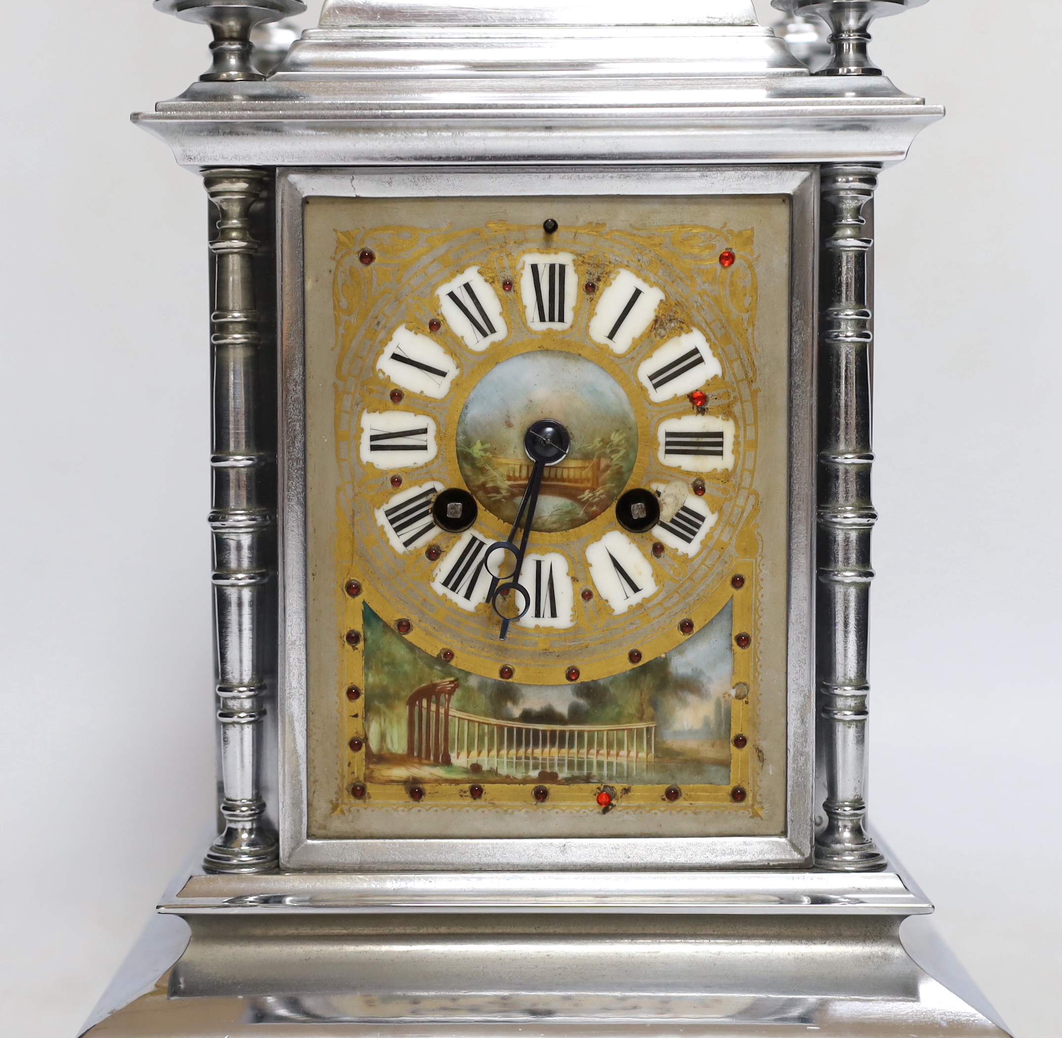 A French chrome plated mantel clock, with jewelled porcelain inset panels 32cm